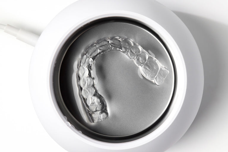 Dentists recommend using an ultrasonic cleaner for aligners